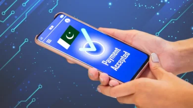 A person holding a smartphone displaying a digital pakistan payment confirmation screen with a "Payment Accepted" message and a Pakistani flag, set against a futuristic tech-themed background.