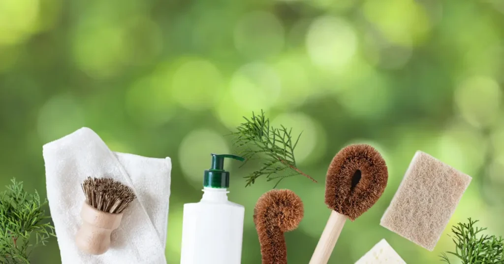 Natural cleaning tools including brushes, Green technology gadgets, towel, and scrub pads on a green Environmentally friendly tech devices background.