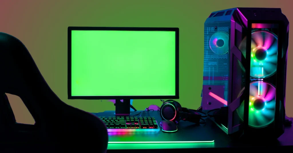 A modern graphic design workstation with a high-resolution monitor, RGB keyboard, and a powerful PC setup with glowing fans.