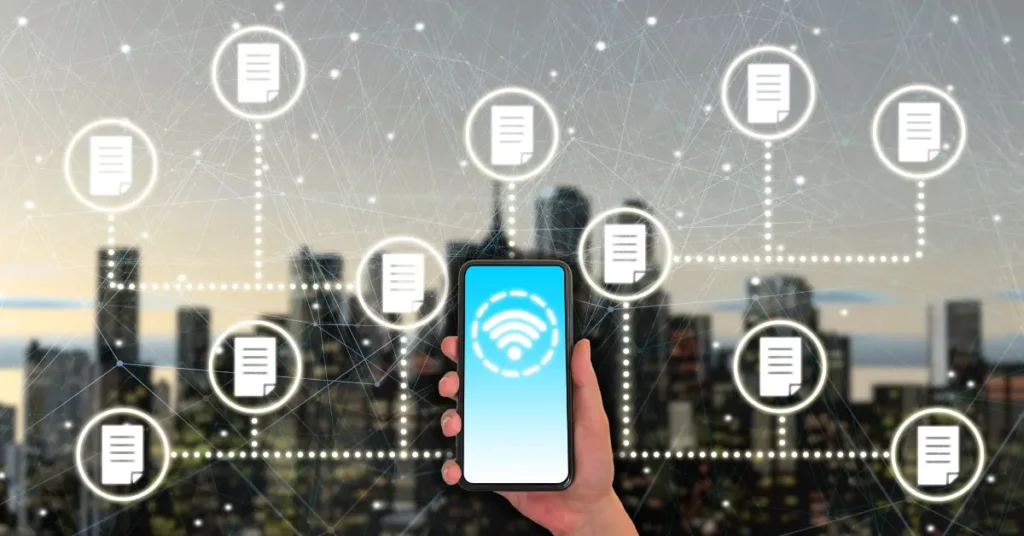 A hand holding a smartphone with a wireless icon on screen, surrounded by floating document icons symbolizing data transfer—perfectly representing tips for switching phones, especially iPhone to Android essentials, and the overall iPhone to Android transition in a connected digital world.