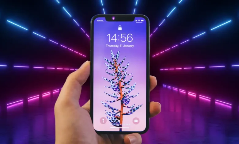 Hand holding a futuristic Apple flip model smartphone with vibrant neon lights in the background.