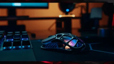 Futuristic gaming mouse with RGB lighting on a tech desk setup, symbolizing next-gen mobile devices and innovative phone designs.