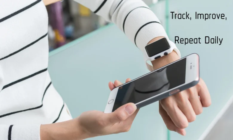 Person checking smartwatch and smartphone, showcasing better habit wearables for daily health tracking.